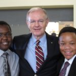 Two cadets with Founder and CEO of Akins Public Strategies, Darrell Akins.